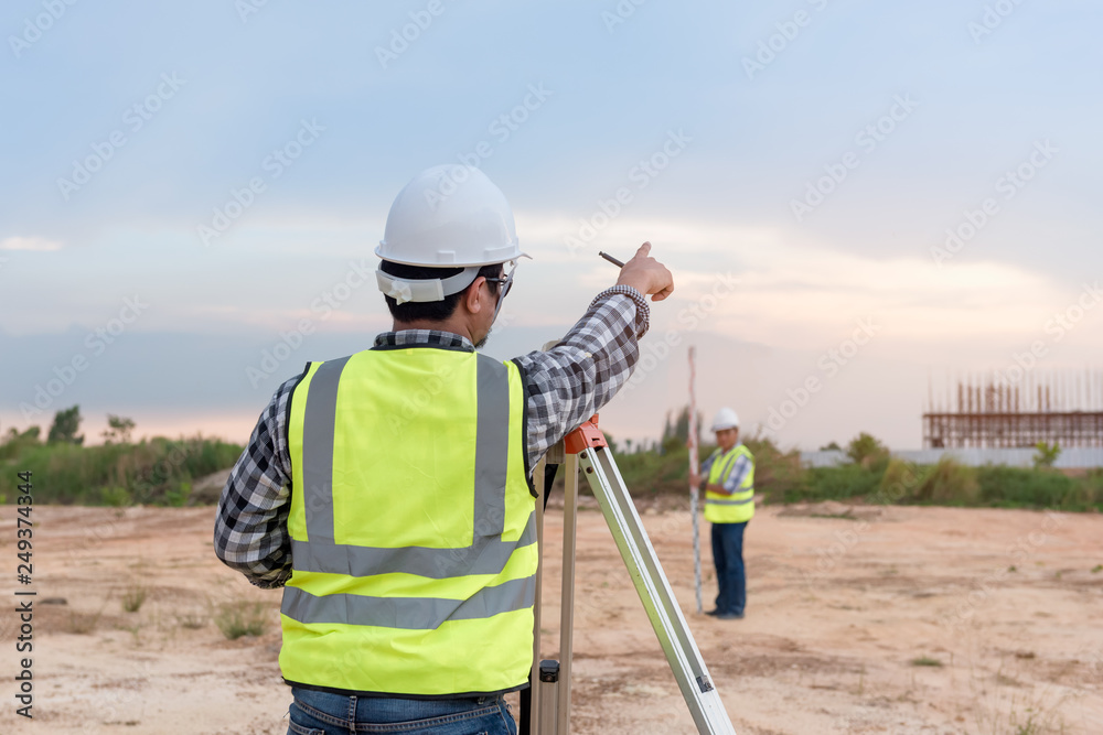 Surveyor equipment. Surveyor’s telescope at construction site or Surveying for making contour plans are a graphical representation of the lay of the land before startup construction work - obrazy, fototapety, plakaty 