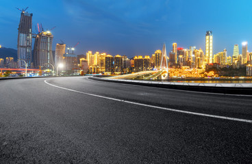 The expressway and the modern city skyline are in Chongqing, China.