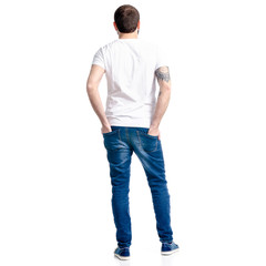 Wall Mural - Man in white t-shirt and jeans standing looking on white background isolation, back view