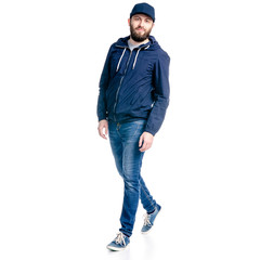 Wall Mural - A man in jeans and jacket walking goes on white background isolation