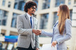 © Mediteraneo - Businessman and businesswomen shaking hands outside office