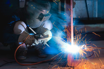 Wall Mural - Welder, welding sparks in the construction and manufacturing in factory