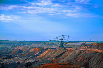 Industrial view of opencast mining quarry with machinery at work. Area has been mined for copper,silver, gold, and other minerals