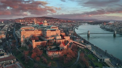 Wall Mural - Budapest, Hungary - 4K flying over Buda Castle Royal palace on a sunny winter day towards Szechenyi Chain Bridge and Parliament at sunrise