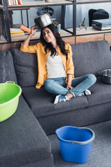 Wall Mural - Funny young woman holding pot above head