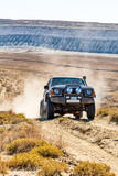 A view of SUV touring on wasteland with no trees blocking our view, Mangystau