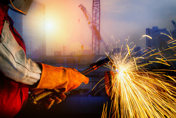 Wall Mural - Jobs Of Professional worker.  Professional worker to cutting steel in the plan of the construction site with Oxy-Propane cutting and mask for protection.