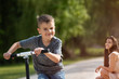 © Martinan - Boy playing with his scooter in park