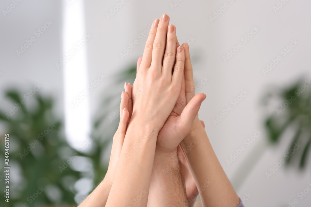 People putting hands together as symbol of unity