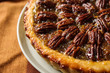 Plate with tasty pecan pie on table, closeup