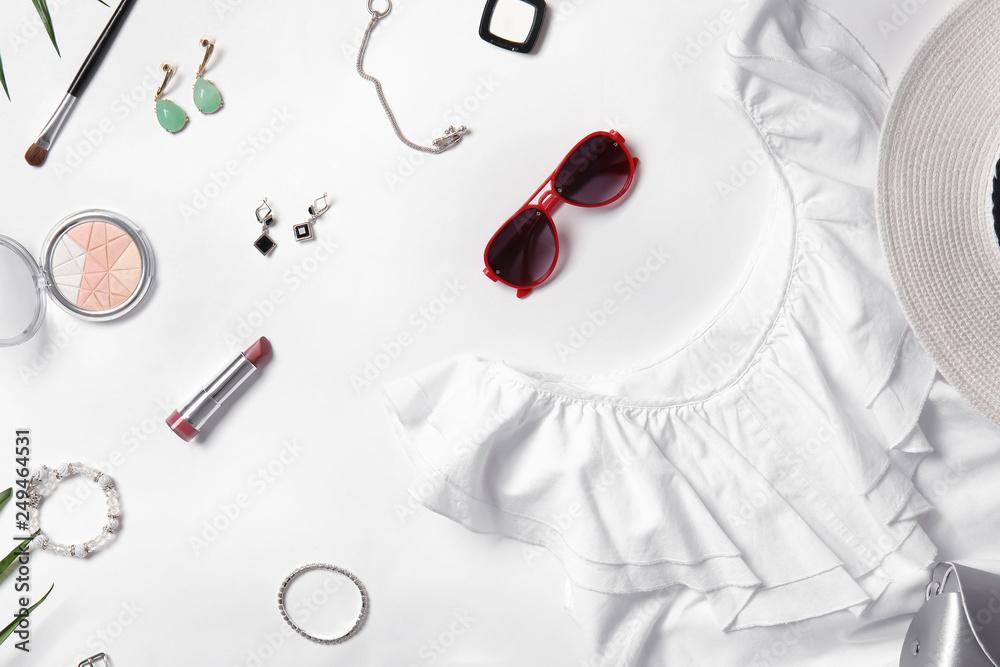 Stylish female clothes and accessories on white background
