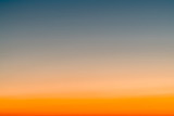 Fototapeta Zachód słońca - Sky gradient from blue to orange sunset