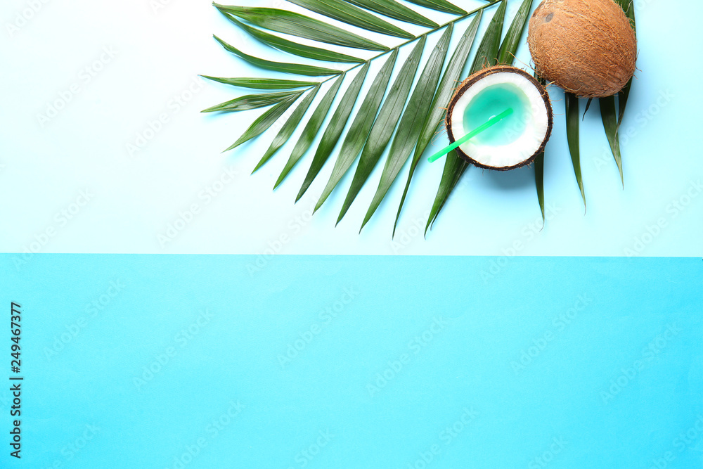 Composition with coconut cocktail and tropical leaf on color background