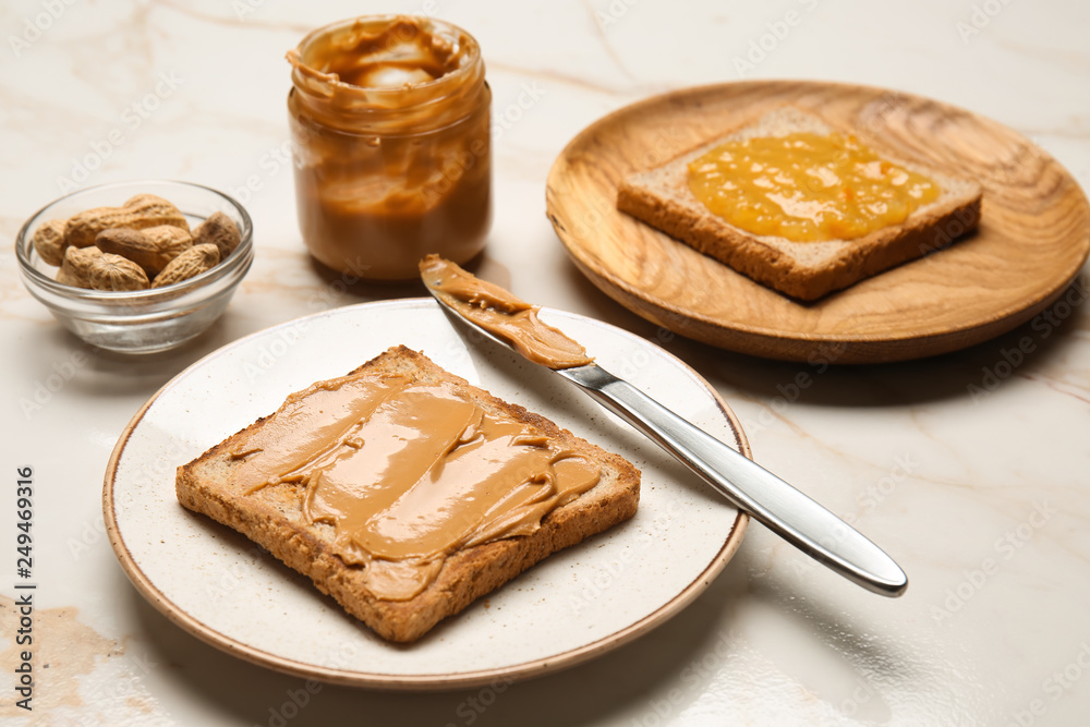 Toasted bread with tasty peanut butter on light table
