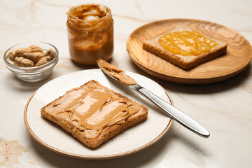 Wall Mural - Toasted bread with tasty peanut butter on light table