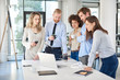 © nenadaksic - Small group of business people standing at office and solving problem at meeting. Multi cultural group.