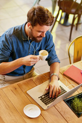 Poster - Male working at laptop and drinks coffee.