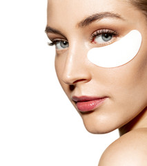 close-up portrait of relaxed woman wearing cosmetic patches under both eyes. wellness skincare and t