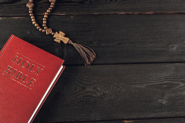 Wall Mural - Bible and a crucifix on an old wooden table. Religion concept.