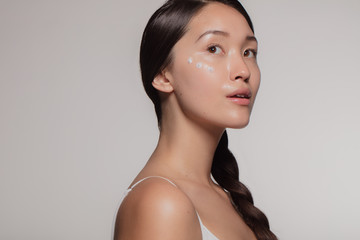 Poster - Woman trying out new cosmetic cream