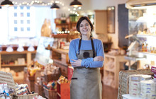 Portrait Of Smiling Female Owner Of Delicatessen Shop Wearing Apron