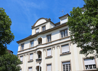 Wall Mural - luxurious building facade seen between trees