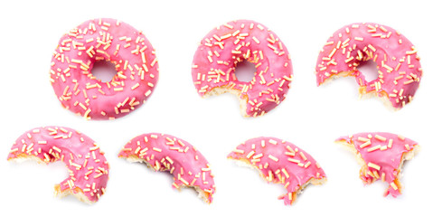 Wall Mural - pink donut biting on white background