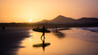 Silhouette of a Surfer on Famara beach at sunset