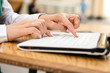 © AnnaDemy - Woman typing on a laptop keyboard in a warm sunny day outdoors, sitting at the cafe table. Space for text