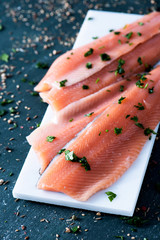 Sticker - slices of raw trout on a white plate