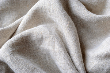 gathered and folded texture of woven linen fabric