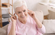 © Prostock-studio - Cheerful aged woman listening to music at home