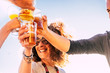 © simona - Close up of people toasting and clinking together with happy and joy and having fun - cheerful people with beer and drinks laughing in friendship - middle age vacation and celebrate activity
