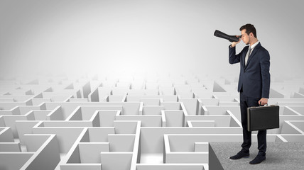Wall Mural - businessman standing on maze and looking forward to the future concept