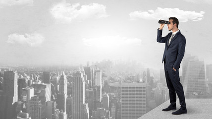 Wall Mural - businessman looking forward to a city with binoculars from skyscraper concept