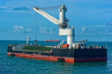 Wall Mural - Floating Crane Transhipper with grab feeding system to cater to bauxite ore transhipment operations from barges at outer anchorage of Kamsar, Guinea.