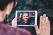 © mlasaimages - Young woman holding a tablet in her hands, having a video call chat with her freelancer boyfriend who is away on business trip. Concept of keeping long distant relationship in career oriented world.