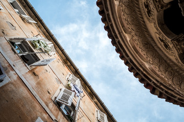 Part of the back wall of Saint Tryphon's Cathedral and the opposite building, shot  from below / upwards in the alley behind the church in Kotor, Montenegro.