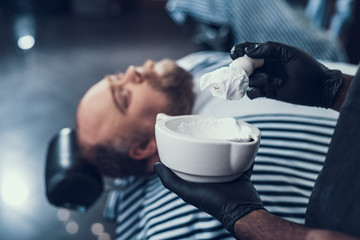 Wall Mural - Calm master preparing shaving foam in white bowl