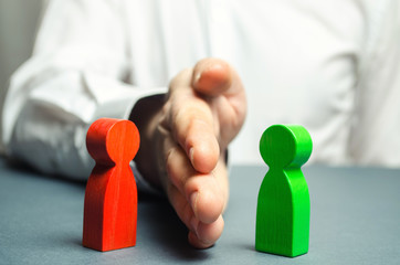 the person divides with the palm the red and green figures of people. orbiter, the solution of contr