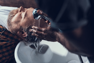 Poster - Hairdresser washing costumer head in white sink