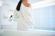© Yakobchuk Olena - Lady put her bathrobe off before bath procedure