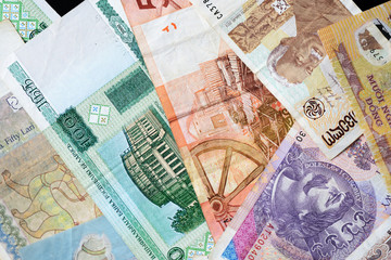 Different countries money background close up. Belarusian rubles, Georgian lari, Polish zloty, Israeli shekels, Vietnamese dongs