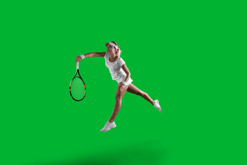 Wall Mural - Girl tennis player on green background.