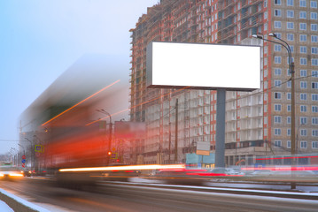 big billboard LED screen near the road in the city. with passing blurred lights of cars. outdoor advertising