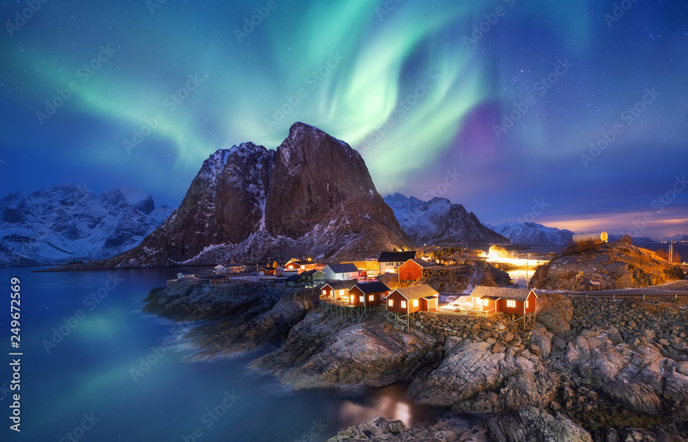 Aurora borealis on the Lofoten islands, Norway. Green northern lights above ocean. Night sky with polar lights. Night winter landscape with aurora and reflection on the water surface. Norway-image - obrazy, fototapety, plakaty 