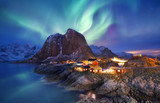 Fototapeta  - Aurora borealis on the Lofoten islands, Norway. Green northern lights above ocean. Night sky with polar lights. Night winter landscape with aurora and reflection on the water surface. Norway-image