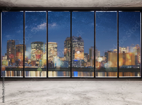 Fototapeta na wymiar Empty modern interior space with city view at night and starry sky, Empty Business Office Interior