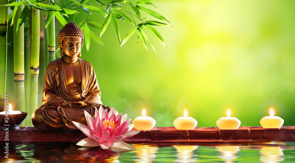 Buddha Statue With Candles In Natural Background - obrazy, fototapety, plakaty 