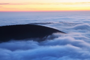 Wall Mural - Beautiful sunset on the highest peak and colorful golden red sky, Krkonose (Giant Mountains), Czech Republic Autumn above the clouds, inversion in mountains. Amazing landscape background concept